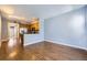 Inviting living space featuring hardwood floors and an open layout to the kitchen at 7453 E 26Th Ave # 2, Denver, CO 80238