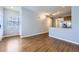 Open-concept living space featuring hardwood floors, a large window, and access to the kitchen at 7453 E 26Th Ave # 2, Denver, CO 80238