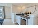 Stylish bar area with a sink, wine refrigerator, and modern decor, perfect for entertaining guests at 6877 Bryant Ct, Denver, CO 80221