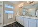 Elegant bathroom with double vanity, modern fixtures, and a glass-enclosed shower at 6877 Bryant Ct, Denver, CO 80221