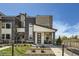 Modern two-story townhome with a covered front porch and professionally landscaped front yard at 6877 Bryant Ct, Denver, CO 80221
