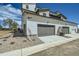 Exterior view of a home with a three-car garage, stone landscaping, and contemporary design at 6877 Bryant Ct, Denver, CO 80221