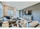 Stylishly designed living room with a large sectional sofa and modern decor at 6877 Bryant Ct, Denver, CO 80221