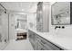 Beautiful bathroom featuring dual sinks, sleek hardware and shower, with a view to the bedroom at 7152 E Hinsdale Pl, Centennial, CO 80112
