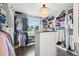 Bright walk-in closet with custom shelving, a stylish chandelier, and ample storage space at 7152 E Hinsdale Pl, Centennial, CO 80112