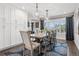 Bright dining room with hardwood floors, large windows, and stylish pendant lights for a comfortable ambiance at 7152 E Hinsdale Pl, Centennial, CO 80112