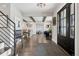 Inviting foyer with hardwood flooring, opening to a living area with beamed ceilings and stylish furnishings at 7152 E Hinsdale Pl, Centennial, CO 80112