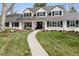 Charming two-story home with a manicured lawn, rock landscaping, and a winding walkway to the front door at 7152 E Hinsdale Pl, Centennial, CO 80112