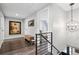 Upstairs hallway features hardwood floors, and a decorative light fixture adding architectural detail and interest at 7152 E Hinsdale Pl, Centennial, CO 80112