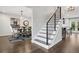 Hallway with a staircase leading to a dining area and a glimpse of a modern kitchen at 7152 E Hinsdale Pl, Centennial, CO 80112