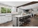 Open kitchen with white cabinets, a large island with seating, and stainless steel appliances at 7152 E Hinsdale Pl, Centennial, CO 80112