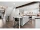 Kitchen island with gray cabinets, seating, and views into other living spaces at 7152 E Hinsdale Pl, Centennial, CO 80112