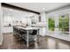 Bright kitchen with island seating, white cabinets, and stainless steel appliances at 7152 E Hinsdale Pl, Centennial, CO 80112