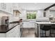 Modern kitchen with sleek countertops, stainless steel appliances, and ample natural light from the window at 7152 E Hinsdale Pl, Centennial, CO 80112