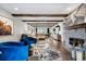 Comfortable open-concept living room showcases exposed beams, decorative fireplace, and seating for easy entertaining at 7152 E Hinsdale Pl, Centennial, CO 80112
