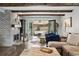 Inviting living room with brick fireplace, wood beams, and comfortable seating arrangement at 7152 E Hinsdale Pl, Centennial, CO 80112