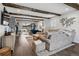 Open-concept living room with wood beams, grey sofa, and view to outdoor patio at 7152 E Hinsdale Pl, Centennial, CO 80112