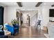 Bright living room showcasing beautiful hardwood floors, exposed beams, and an open floor plan to the dining area at 7152 E Hinsdale Pl, Centennial, CO 80112