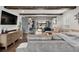 Bright living room with a brick fireplace, wood beams, and outdoor access at 7152 E Hinsdale Pl, Centennial, CO 80112