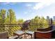 Cozy balcony with stylish wicker seating, trees and neighborhood views at 907 E 22Nd Ave, Denver, CO 80205