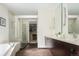 Modern bathroom featuring double sinks, bathtub, and walk-in shower with glass door at 907 E 22Nd Ave, Denver, CO 80205