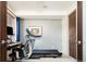 Neutral bedroom featuring a computer, treadmill and a dark wood door at 907 E 22Nd Ave, Denver, CO 80205