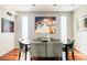 Stylish dining room with wood floors, modern art, and seating for six at 907 E 22Nd Ave, Denver, CO 80205