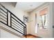 Bright entryway featuring a modern staircase with metal railings and a glass front door at 907 E 22Nd Ave, Denver, CO 80205