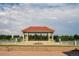 A picturesque gazebo with a red tile roof sits by the water, offering a scenic spot for relaxation at 907 E 22Nd Ave, Denver, CO 80205