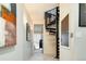 Hallway featuring a black spiral staircase, art on the walls, and a door leading to another room at 907 E 22Nd Ave, Denver, CO 80205