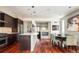 Open concept kitchen and dining area with hardwood floors and cozy fireplace at 907 E 22Nd Ave, Denver, CO 80205