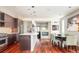 Open-concept kitchen flowing into the dining area, featuring hardwood floors and stainless appliances at 907 E 22Nd Ave, Denver, CO 80205