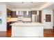 Modern kitchen with stainless steel appliances, pendant lighting, and a large island at 907 E 22Nd Ave, Denver, CO 80205