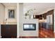 Open-concept living area with a fireplace, bar, and a glimpse into the modern kitchen at 907 E 22Nd Ave, Denver, CO 80205