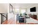Open living space with hardwood floors, a balcony view, and contemporary furnishings at 907 E 22Nd Ave, Denver, CO 80205
