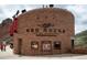 Exterior view of the Red Rocks museum entrance, featuring stone architecture and signage at 907 E 22Nd Ave, Denver, CO 80205