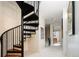 Hallway with a stunning black spiral staircase with wood treads that leads to the next level of the home at 907 E 22Nd Ave, Denver, CO 80205