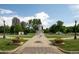 A stately statue stands prominently amidst green lawns and trees, with city buildings in the background at 907 E 22Nd Ave, Denver, CO 80205