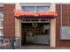 Sweet Action ice cream storefront featuring a retro sign, brick facade, and a glimpse inside the colorful interior at 907 E 22Nd Ave, Denver, CO 80205