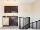 Convenient wet bar featuring dark wood cabinetry, a stainless steel refrigerator, and a sink at 907 E 22Nd Ave, Denver, CO 80205
