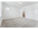 Spacious bedroom with neutral carpet, natural light, and ensuite bathroom access at 16478 W 92Nd Pl, Arvada, CO 80007