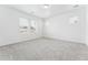 Neutral bedroom featuring carpet floors, white walls, and natural light from multiple windows at 16478 W 92Nd Pl, Arvada, CO 80007