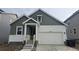 Charming two-story home featuring a two-car garage, landscaped yard, and inviting front entrance at 16478 W 92Nd Pl, Arvada, CO 80007