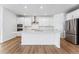 Bright kitchen with a large island, stainless steel appliances, and a modern design at 16478 W 92Nd Pl, Arvada, CO 80007