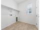 Laundry room with tile flooring and a window providing natural light at 16478 W 92Nd Pl, Arvada, CO 80007