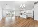 Bright open floor plan combining the living room and kitchen, featuring wood floors at 16478 W 92Nd Pl, Arvada, CO 80007