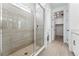 Modern walk-in shower with glass door and tile surround in a bright bathroom at 16478 W 92Nd Pl, Arvada, CO 80007