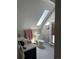 Bright bathroom with skylight, toilet, sink, and mirrored cabinet at 819 27Th St, Denver, CO 80205