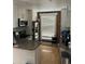 Well-lit kitchen features stainless steel appliances, a brick wall accent, and wood flooring at 819 27Th St, Denver, CO 80205