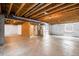 Partially finished basement with exposed beams, white wrapped walls, and a concrete floor at 1339 Sidewinder Cir, Castle Rock, CO 80108